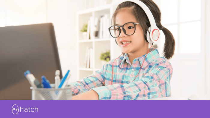 Girl smiling coding at her computer