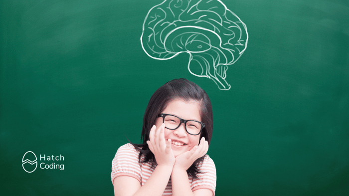 Girl smiling because she's learning to code