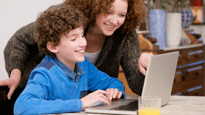 Mom and son engaged with his coding projects