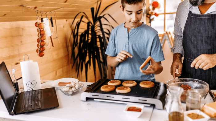 Boy cooking with his Dad